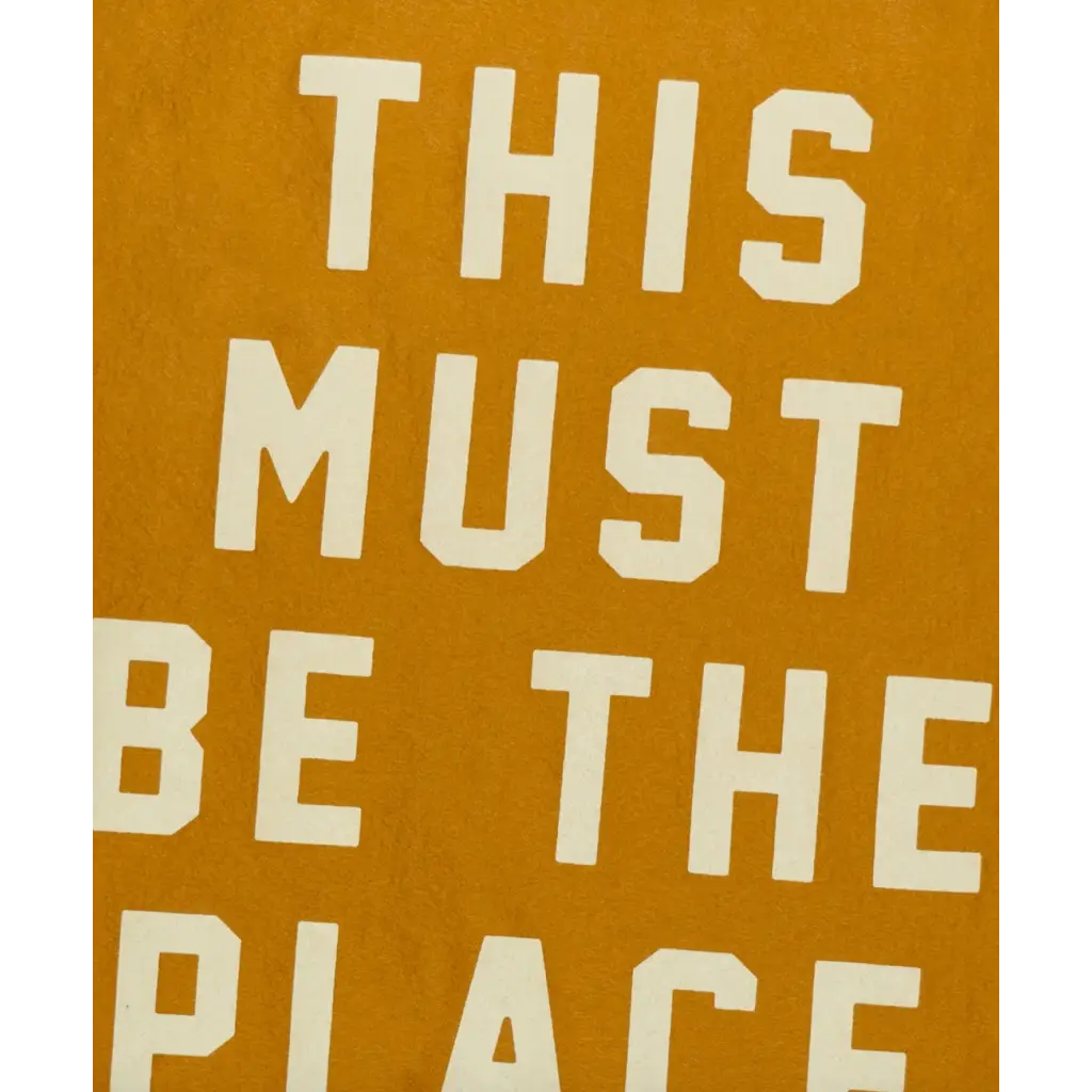 Text art on mustard background featured on This Must Be the Place Camp Flag, perfect for stylish womens clothes