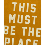 Text art on mustard background featured on This Must Be the Place Camp Flag, perfect for stylish womens clothes
