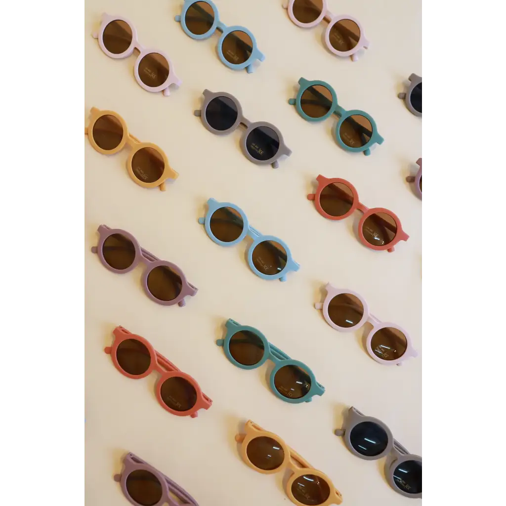 Collection of pastel round retro sunglasses for babies and toddlers arranged stylishly