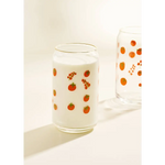 Clear glass cup with red berry pattern and white milk, perfect for stylish womens clothes