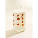 Glass can-shaped tumbler with fruit pattern and white drink, perfect for stylish womens clothes