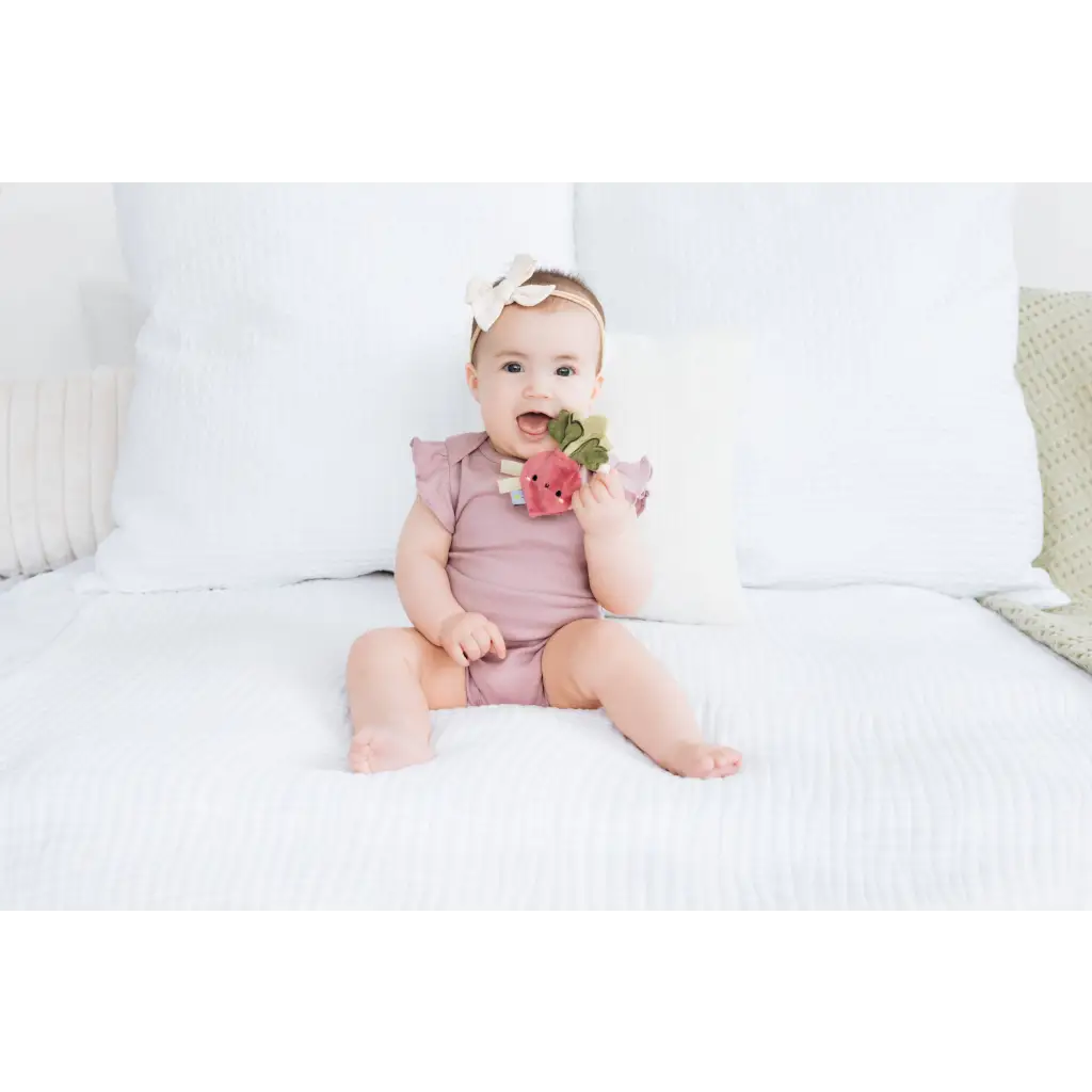 Cute baby pink romper with ruffles, florals, and Turnip Crinkle Baby Teether beaded ring