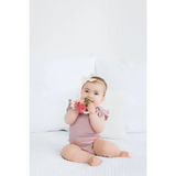 Lavender ruffled romper with bow detail on Turnip Crinkle Baby Teether