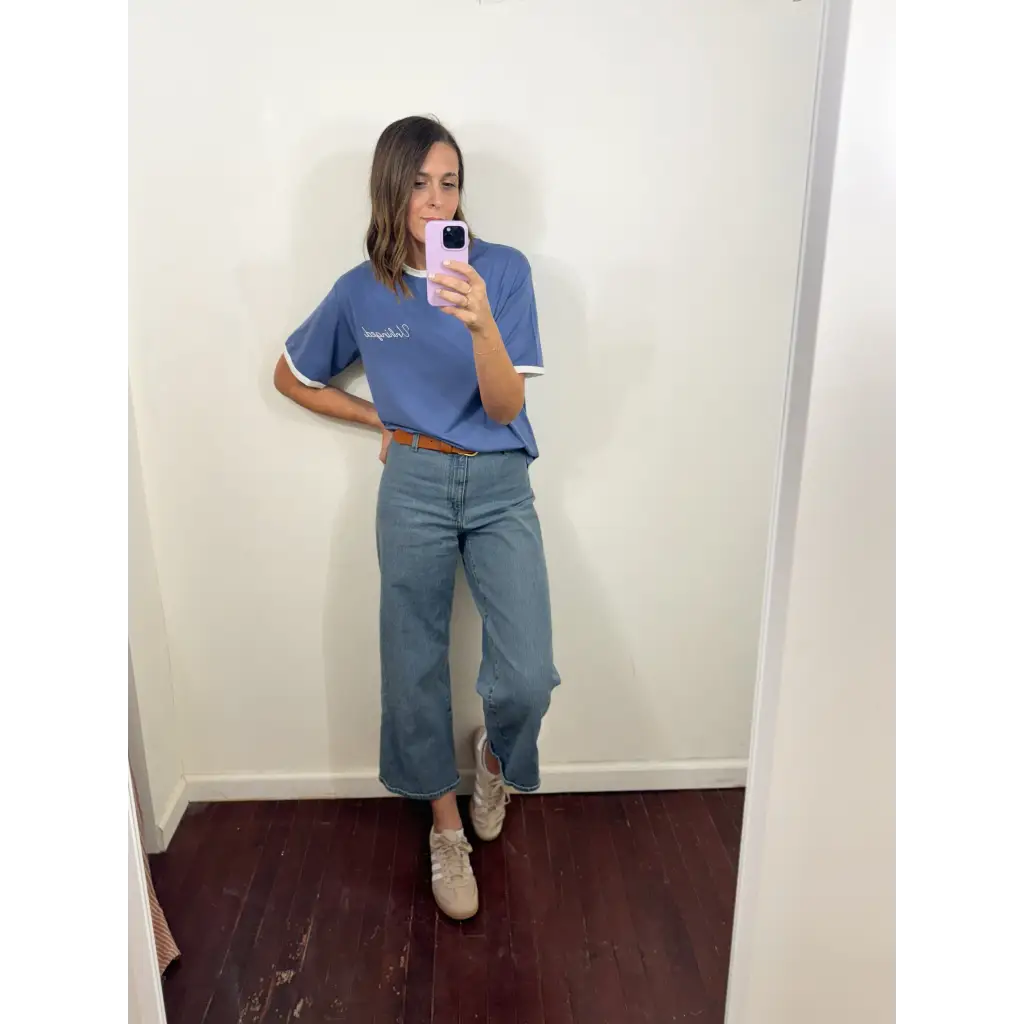 Mirror selfie of a person in a blue polo and wide-leg cropped jeans with a ringer tee