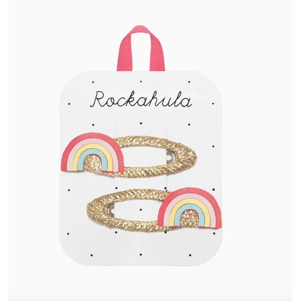 Two glittery gold rainbow clips with pastel rainbows for stylish women’s clothes