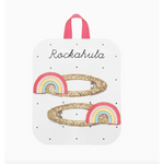Two glittery gold rainbow clips with pastel rainbows for stylish women’s clothes