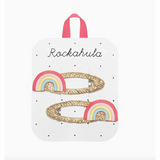 Two glittery gold rainbow clips with pastel rainbows for stylish women’s clothes