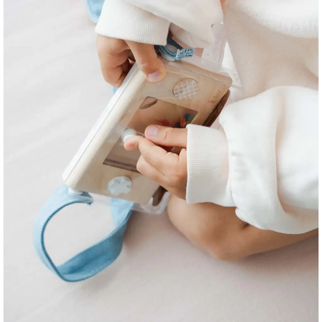 Hands in white sleeves hold a medical device beside Wakka Retro Water Game