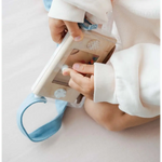 Hands in white sleeves hold a medical device beside Wakka Retro Water Game