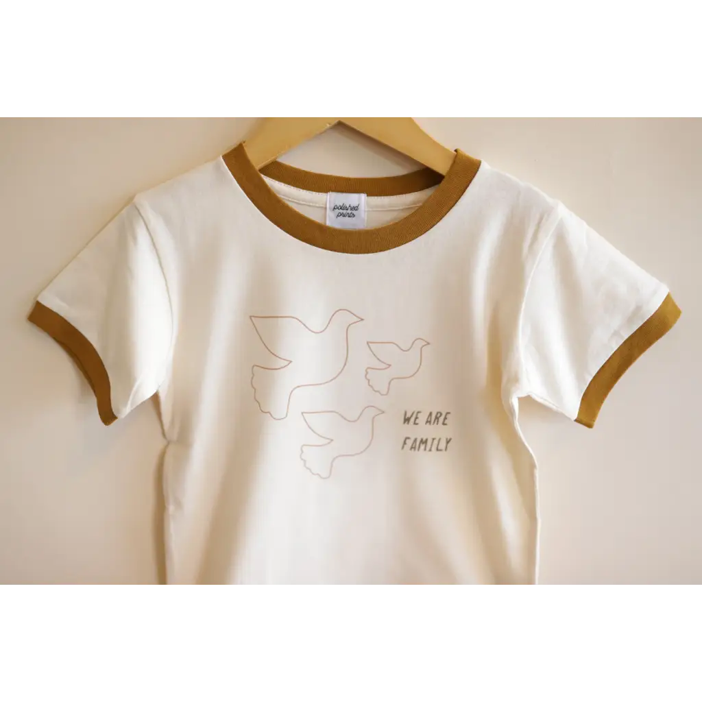 White Everyday Ringer Tee for Kids with Dove Designs and WE ARE FAMILY text