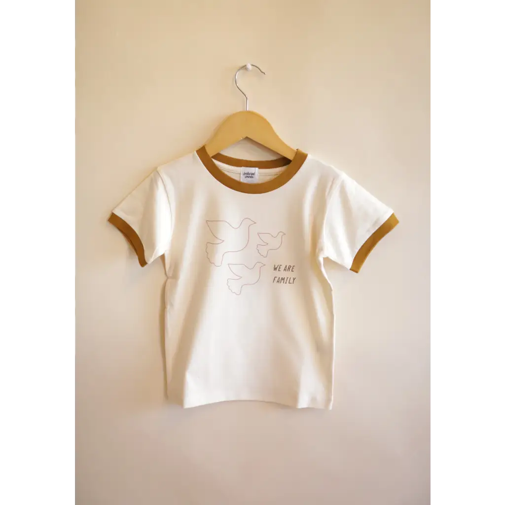 White Everyday Ringer Tee for Kids with Dove Designs hanging on a hanger