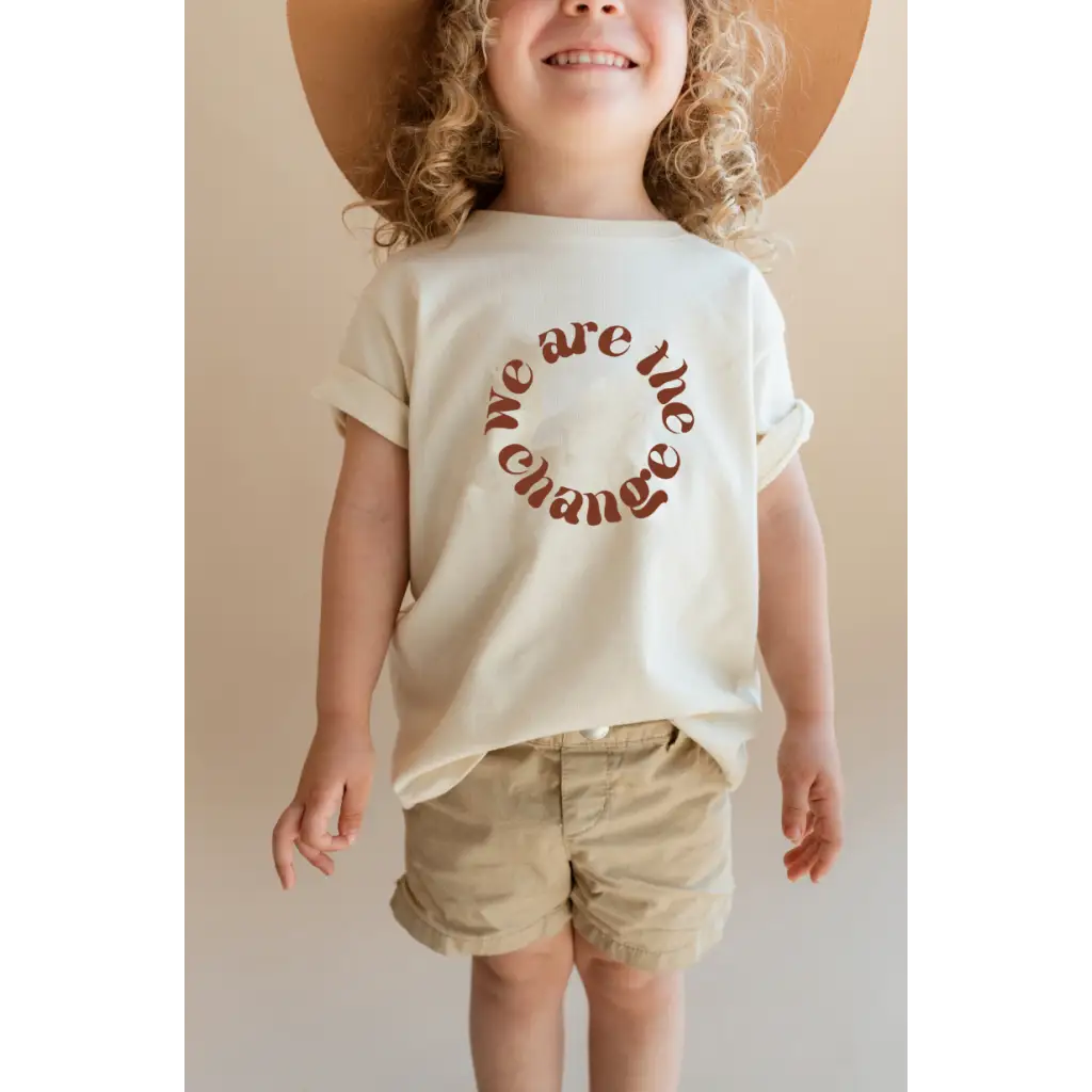 White organic cotton kids graphic tee featuring polished prints with We are the change design