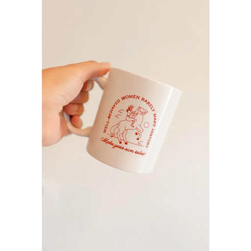 White ceramic mug with red line art of a woman for the Well Behaved Women mug