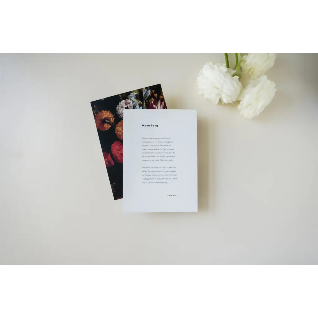 White paper card with text next to floral-patterned card, shipping featuring poetry excerpts