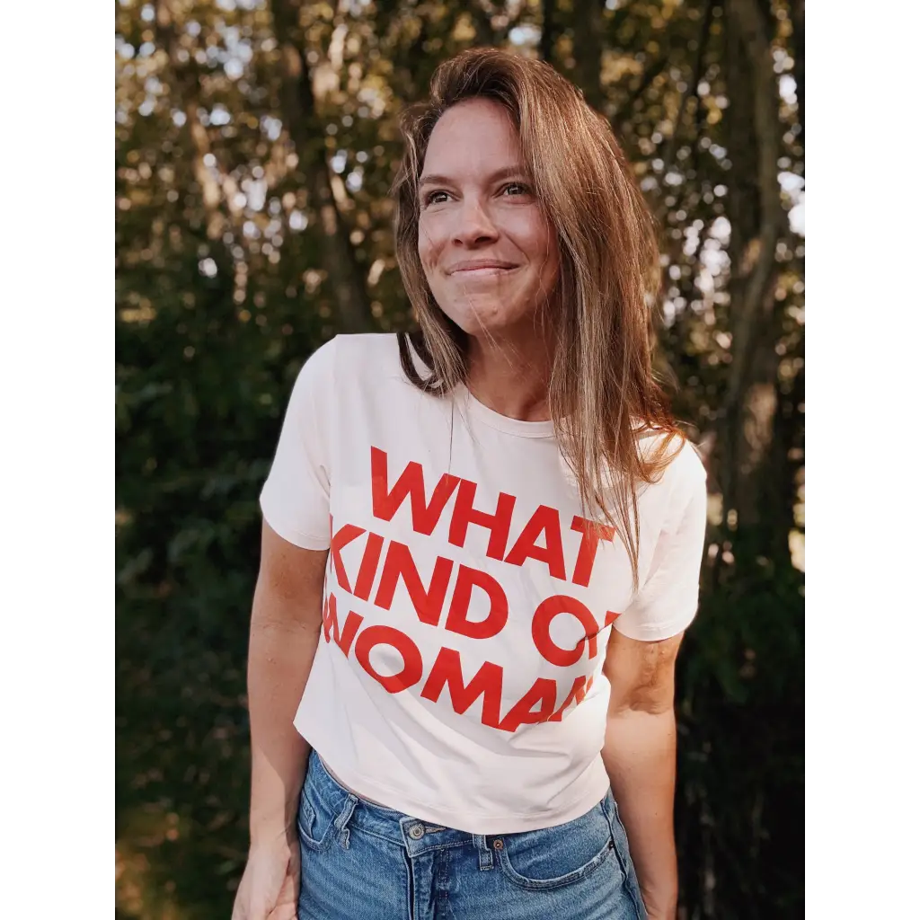 White mom crop t-shirt with red What Kind of Woman text and blue jeans