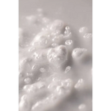 White foam bath bomb with bubbles in Wild Rose Bath Soak jar