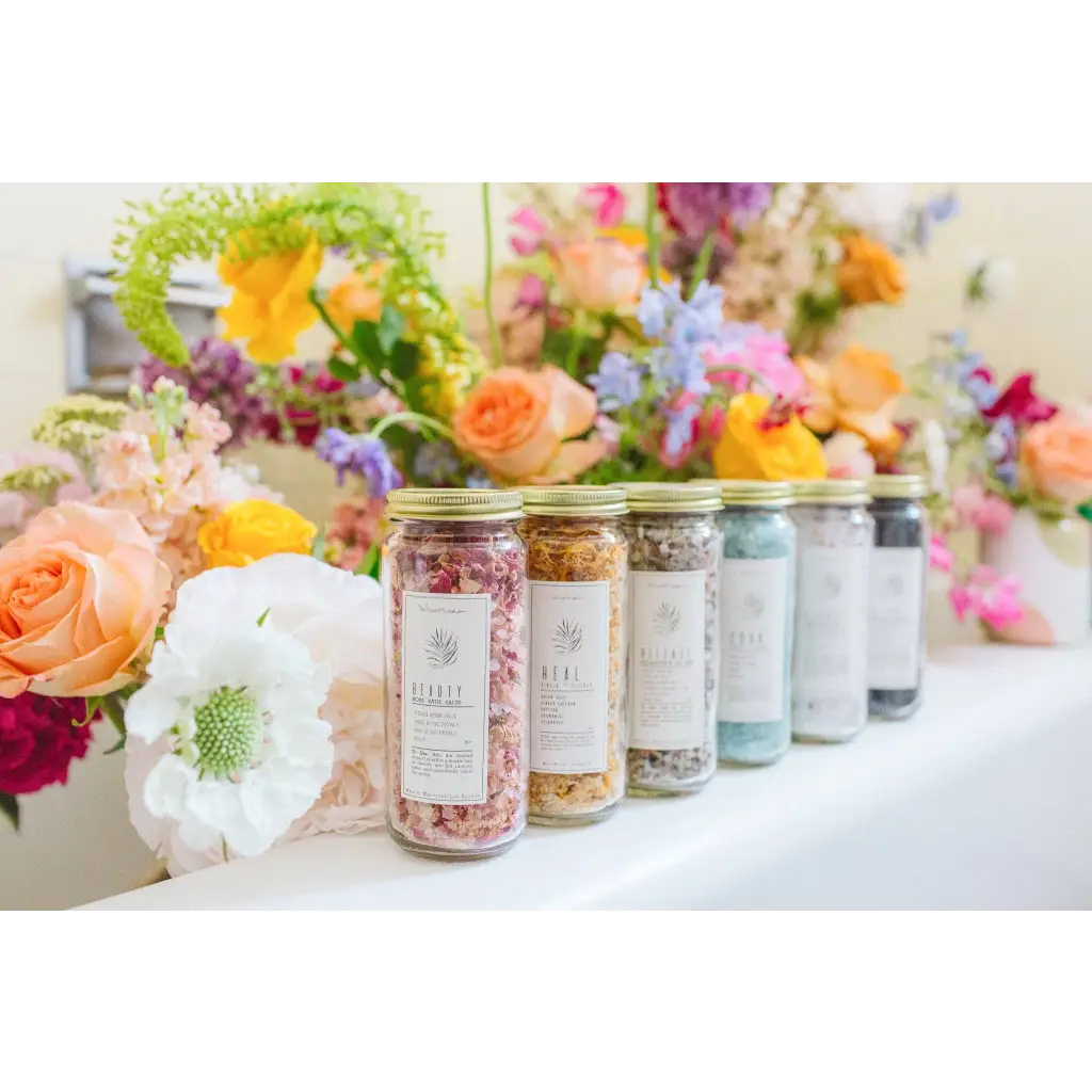 WildFlora bath salts in clear jars with colorful petals and beauty labels