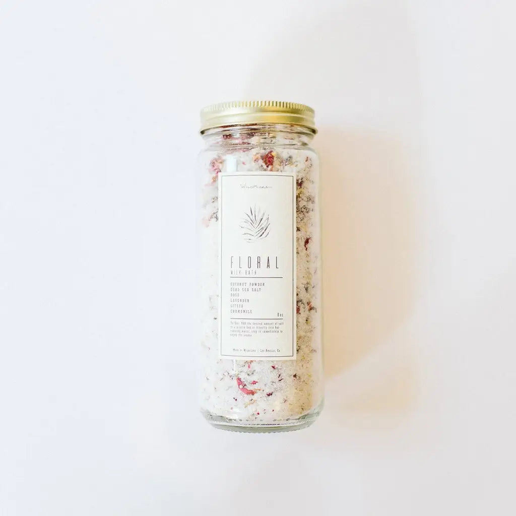 WildFlora floral bath salts in clear jar with pink petals
