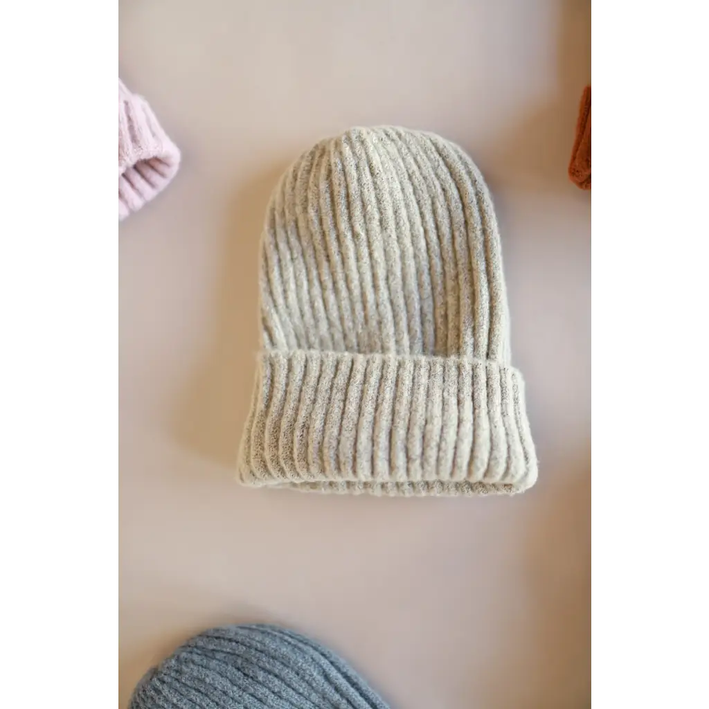 Cream-colored ribbed knit beanie with folded brim from our super soft small collection