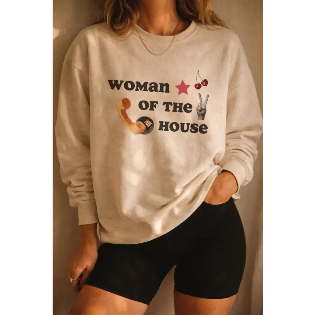 Cream-colored oversized sweatshirt with Woman of the House print, red star, cherries, peace sign. Ultra soft, polished prints