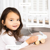 Charming white wooden bunny push toy with natural wood wheels and ears