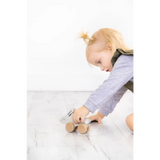 Wooden bunny push toy with tan wheels and silver hood for play