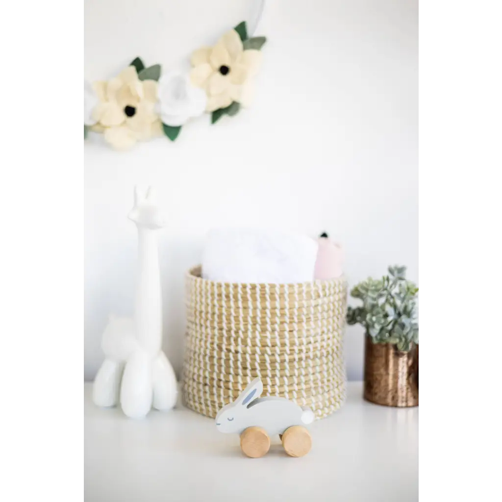 Wooden bunny push toy with woven basket and white interior