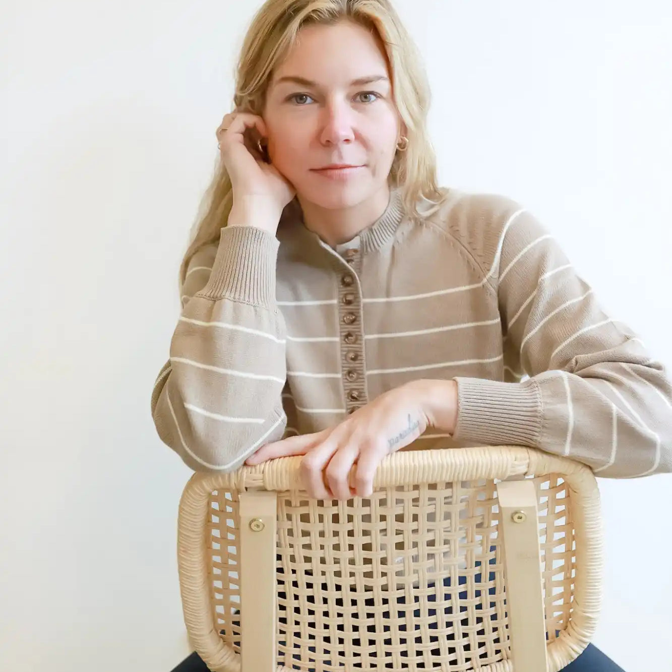 Wooden chair with woven cane backing and seat.