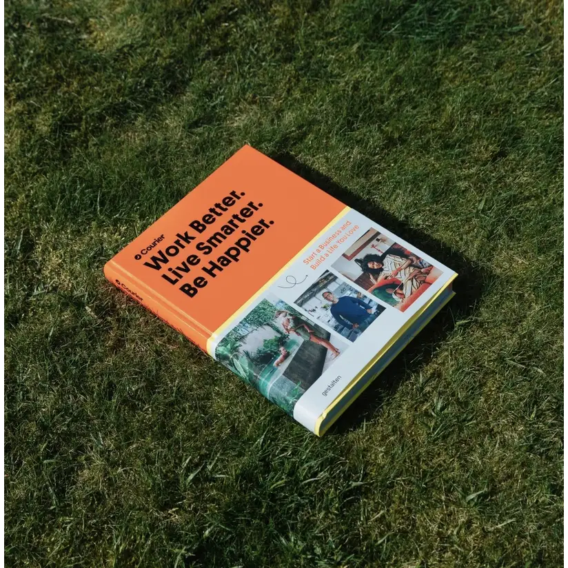 Orange book on grass titled Work Better, Live Smarter, Be Happier about changing conventional habits