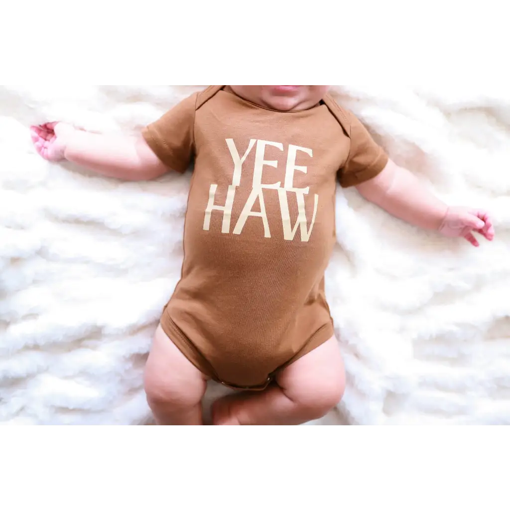 Brown organic cotton baby onesie with Yee Haw text for little cowboys and cowgirls