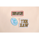 Three decorative Yeehaw iron-on patches with retro western vibes and nostalgic imagery