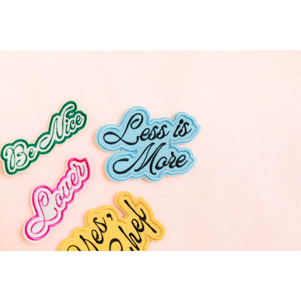 Colorful chef iron-on patch with phrases like Less is More on a soft background