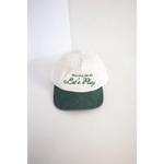 White and green embroidered kids trucker hat with Let’s Play text for fun times